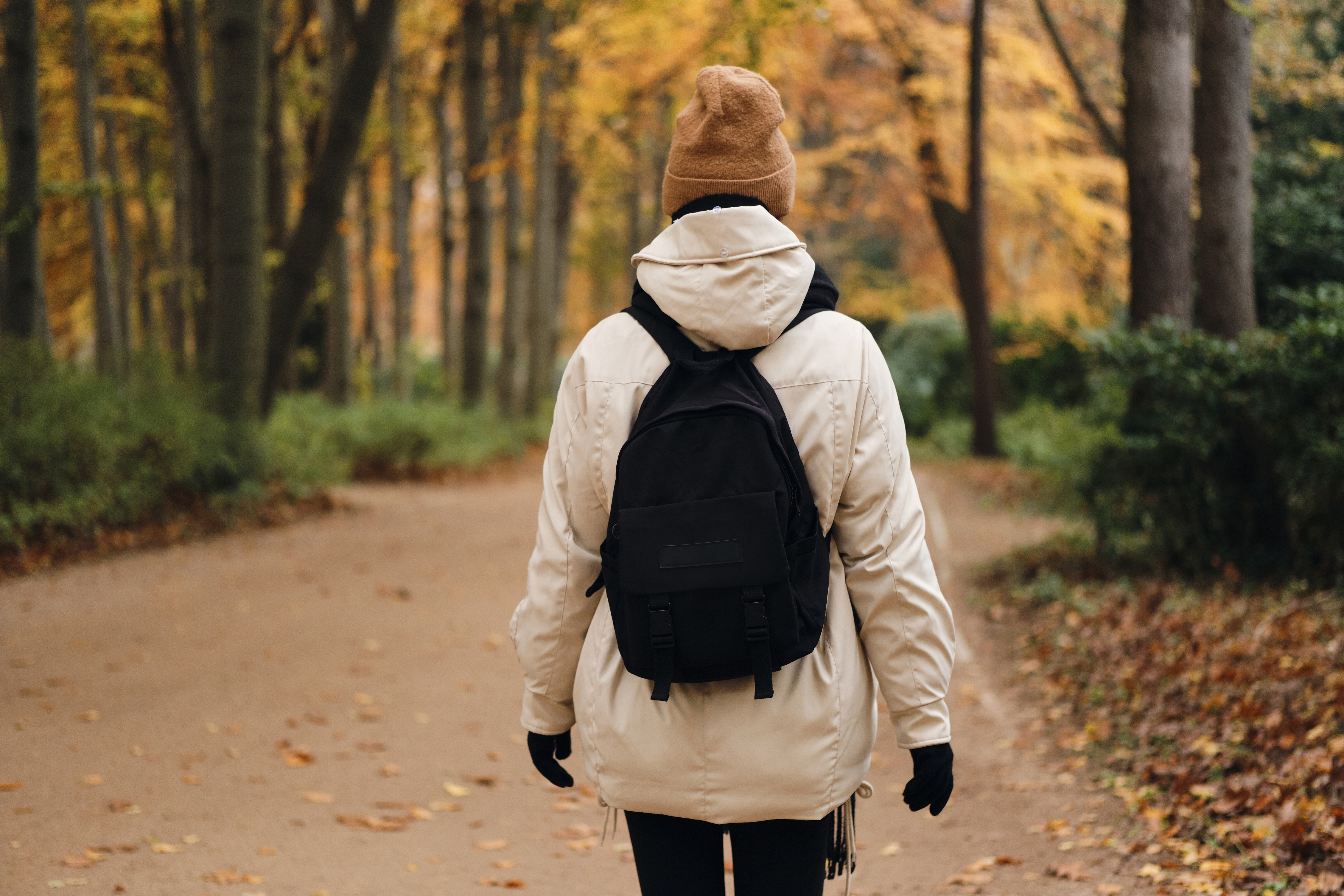 back-view-casual-girl-with-backpack-walking-around-autumn-park-alone.jpg